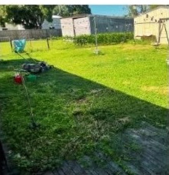 A mown backyard with the clippings raked up
