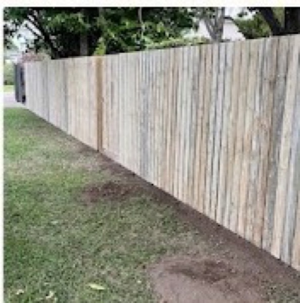 A timber paling fence with a string line set out along it