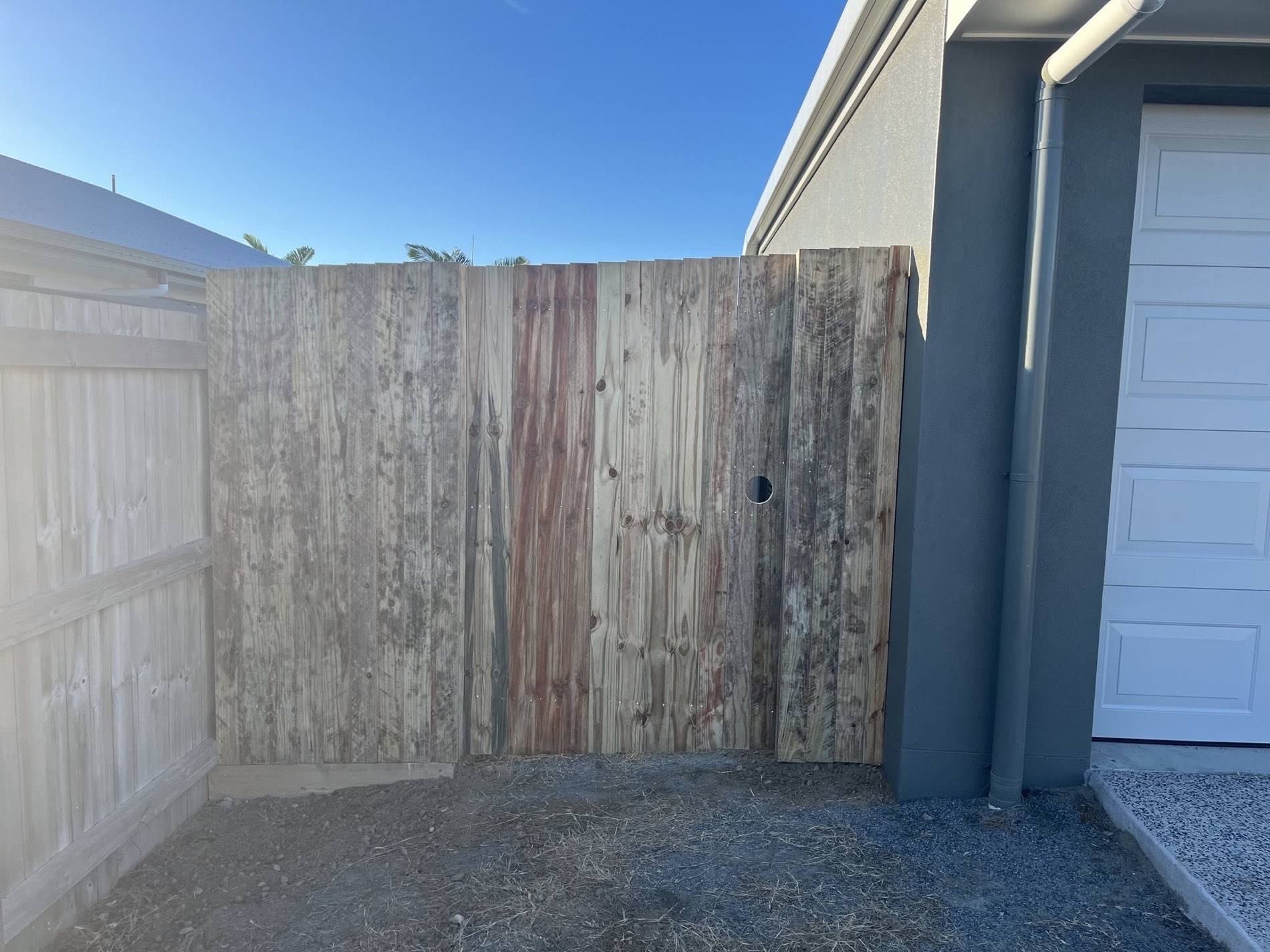 A finished timber fence and gate beside a Mackay home