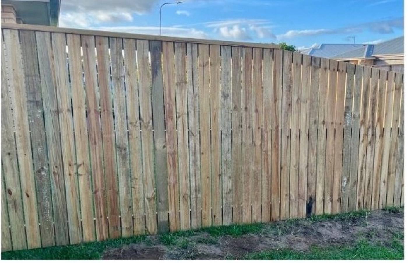 A new timber paling fence line at a Mackay property
