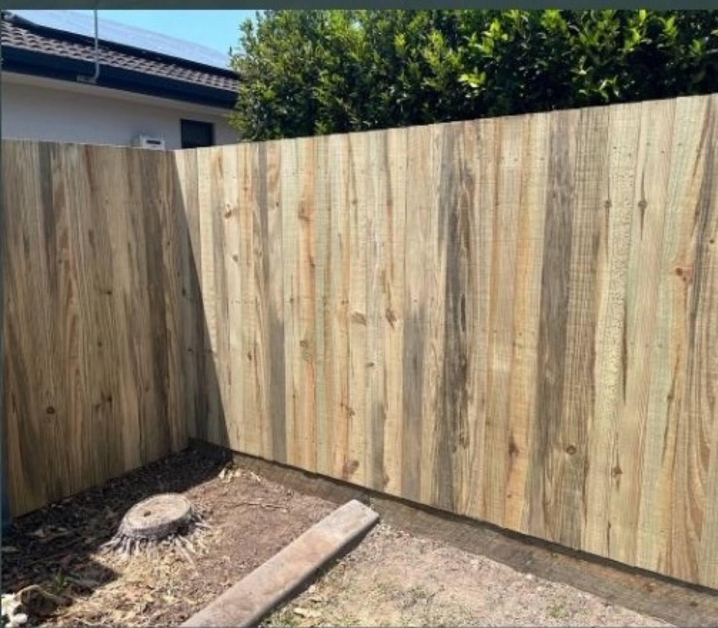 A replaced timber fence section beside an existing fence